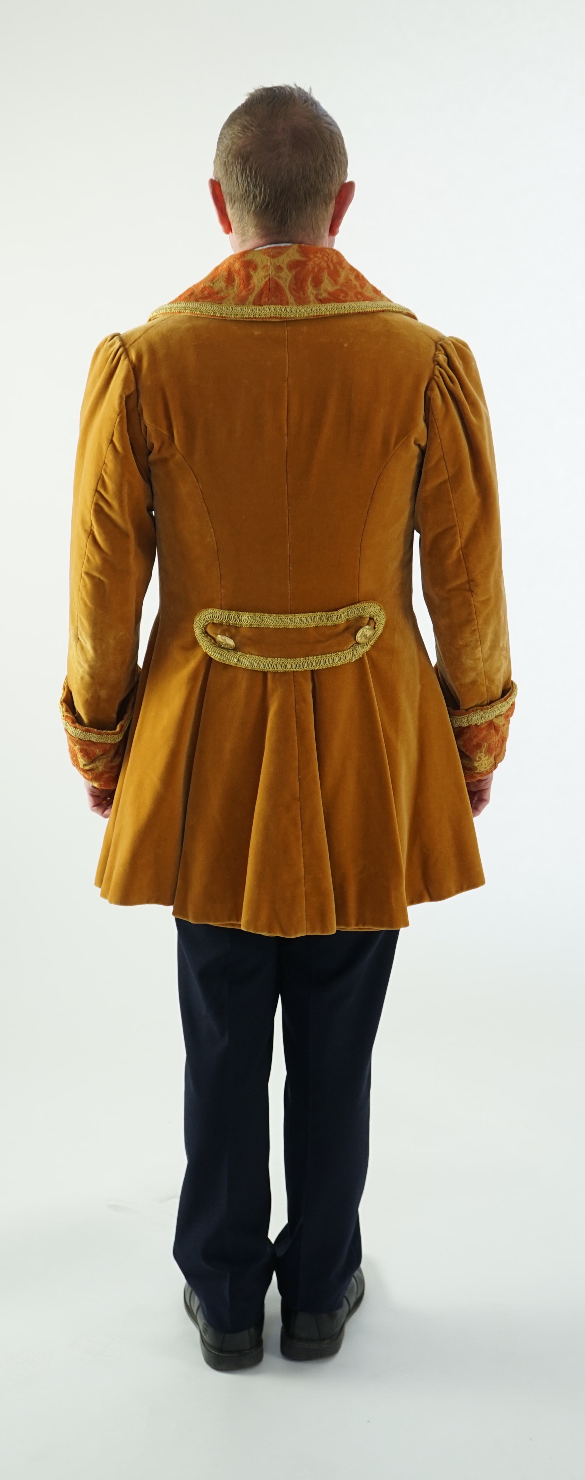 A man's 19th century smoking jacket, mustard velvet, with brocade lapels and cuffs. Ex Royal Opera House 'Arabella'